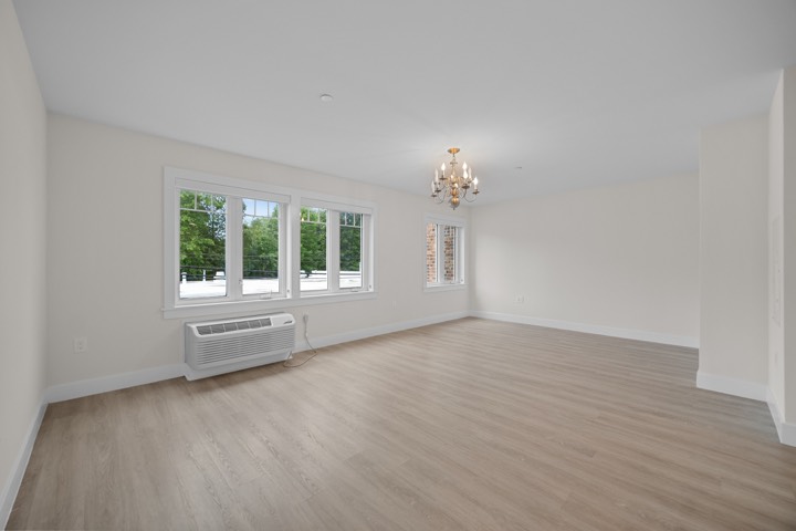 50 Six Calvert, Harrison NY — Living room with chandelier